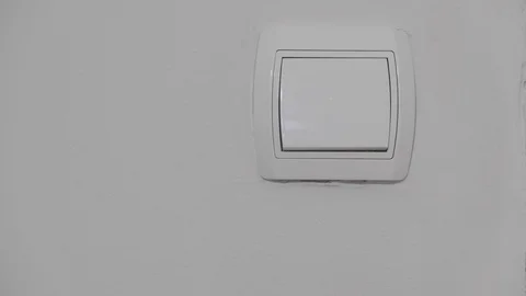 A hand turning the light switch off Stock Footage 121614325