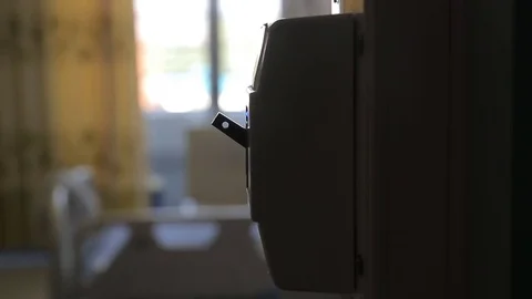 A hand turning on a light switch in a house Stock Footage 78502506