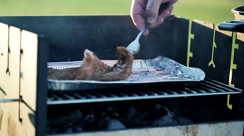 Hand turning meat on the gril HD Видео 49980113