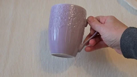 Hand Turning Mug Upright on Table, Everyday Action Concept Stock Footage 336898063
