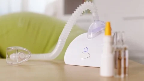 Hand turning on nebuliser inhaler device Stock Footage 80353791