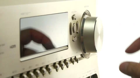Hand turning up or down the volume on a av receiver Stock Footage 51207264