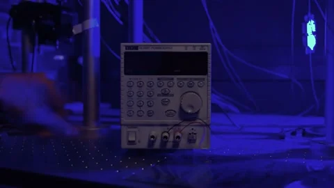 Hand turning on an oscilloscope, a measuring tool in a laboratory Stock Footage 210225559