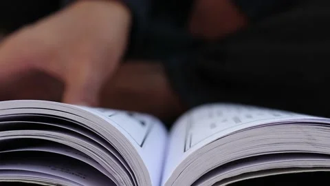 Hand Turning Pages of a Book, CLOSE UP.  Unrecognizable Person's Stock Footage 144090771