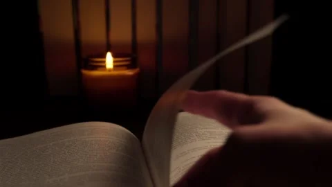 Hand turning pages of an open book on a wooden table Stock Footage 315764470
