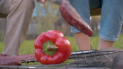 Hand turning pieces of meat Stock Footage 130814059
