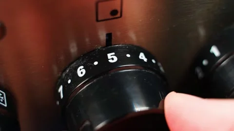 Hand turning the power control knob of an electric stove, close-up Stock Footage 322170552