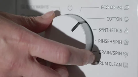 Hand turning the program dial on a washing machine Stock Footage 330574263