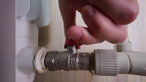 Hand Turning Red Ball Valve on Heating Radiator Pipe Inside Home 库存影片 339212490