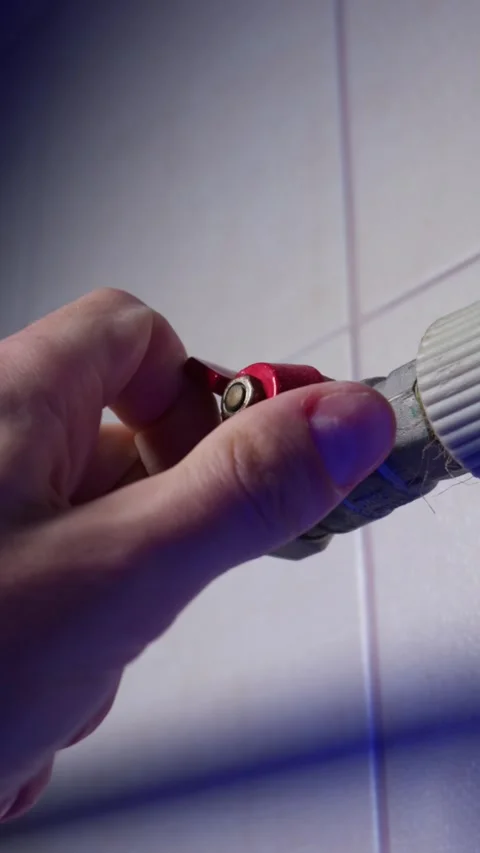 Hand Turning Red Lever Valve to Shut Off Water or Heating Pipe Supply Stock Footage 339213582