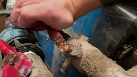Hand turning rusty valve on old water pipe Stock Footage 319802371