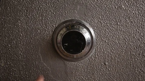 Hand turning a safe combination lock and leave frame Stock Footage 86894844