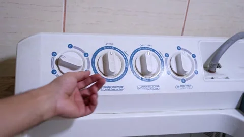 Hand Turning Semi-Automatic Washing Machine Timer Knob Stock Footage 323177204