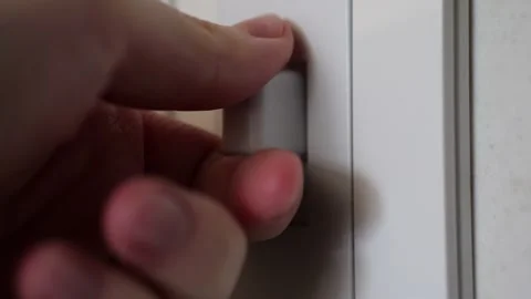 Hand turning a shredder switch on and off in slow motion Stock Footage 306193348