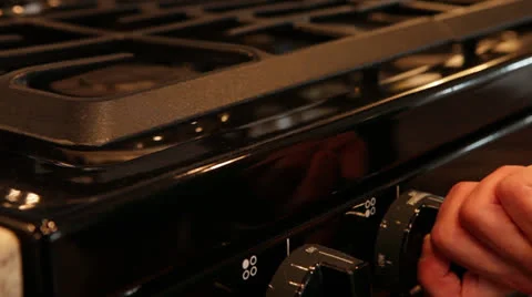 Hand Turning on stove, close-up Stock Footage 25912738