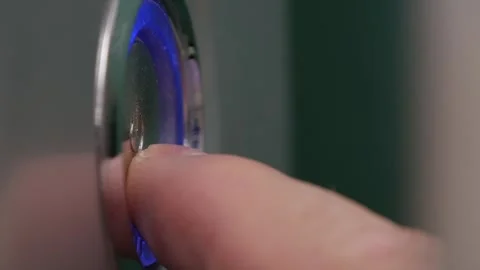 Hand Turning On the Switch, Starting a Device. One Finger Pressing the Power Stock Footage 335511855