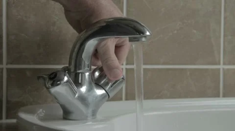 Hand turning tap on Stock-Footage 8992980