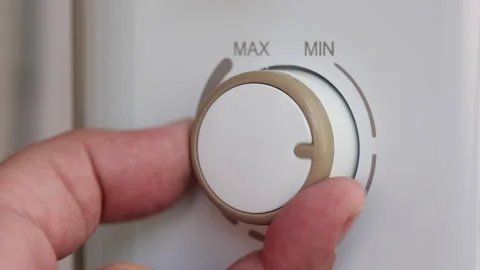 Hand Turning Temperature Knob On Electric Oil Heater Radiator. Stock Footage 284840934