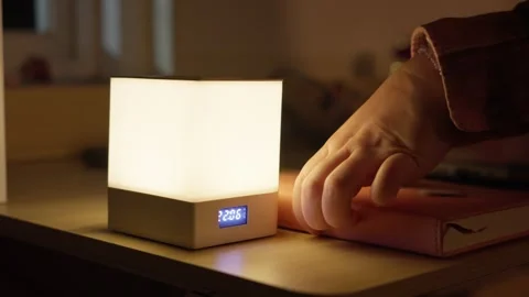 Hand Turning On Touch Bedside Lamp with Digital Clock Stock Footage 344946008