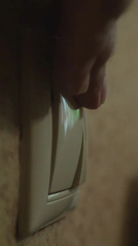 A Hand Turning On A Wall Light Switch With Room Illumination. Vertical. Stock Footage 303482830