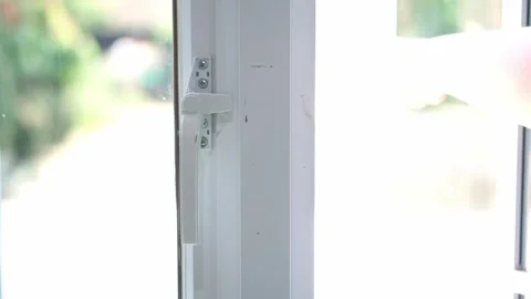 Hand turning a window latch to open the glass window at home. Stock Footage 339873289
