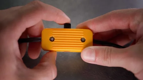 The hand turns on and off the old yellow plastic switch from the bedside light Stock Footage 217440909