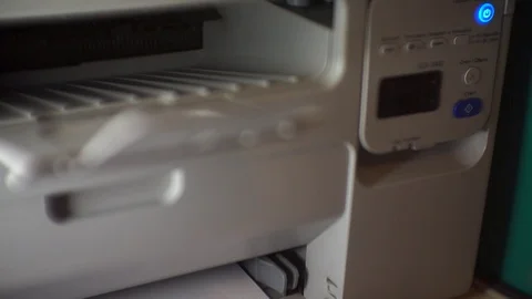The hand turns on the button and printing begins. video with glare Stock Footage 123744137