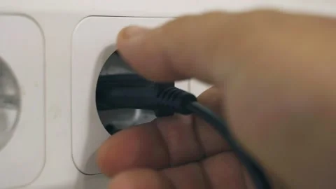 The hand turns off the device from the electrical network. 動画素材 200874424