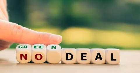 Hand turns dice and changes the expression "no deal" to "green deal". Stock Photos