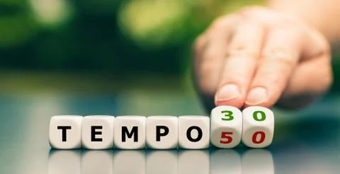 Hand turns dice and changes the expression "tempo 50" ("speed limit 50") to " Stock Photos