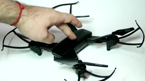 A hand turns on the drone and the lights start to flash, turns off the drone Stock Footage 342257015