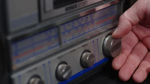 A hand turns the frequency knob on an old gray tape recorder - close-up Stock Footage 170717701