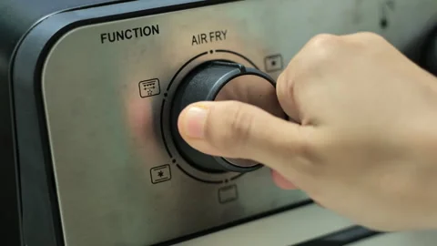 A hand turns the function knob of a microwave and air fry oven. 스톡 동영상 246399630
