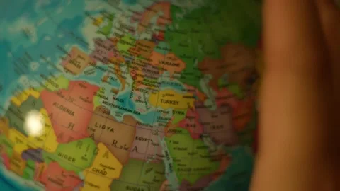 Hand turns globe slowly over North Pacific Ocean Stock Footage 342353630