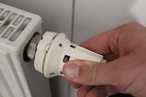 Hand turns the heating wheel Stock Photos