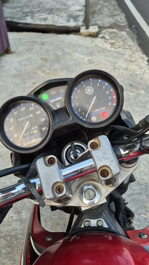 A hand turns on the ignition of a motorcycle Stock Footage 339976472
