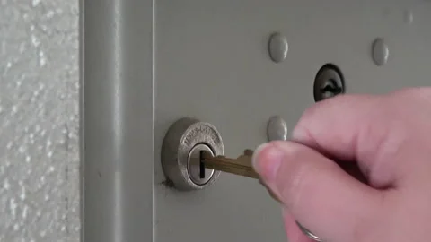 Hand turns key to unlock open mail post office box to retrieve Amazon Stock Footage 143755004