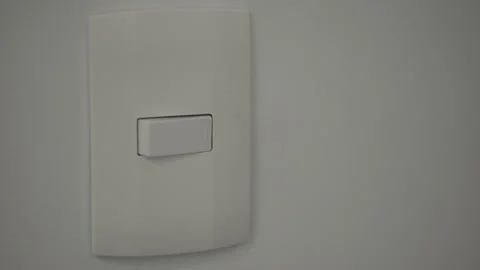 A hand turns a light switch off and on Stock Footage 280096019
