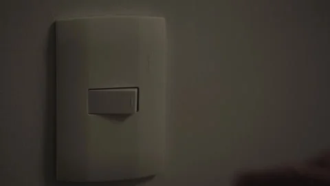 A hand turns a light switch off and on Stock Footage 280096094