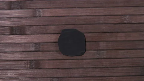 The hand turns the object that turns out to be a pirate black mark of death Stock Footage 104608648