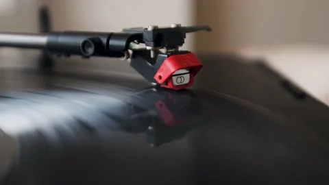 The hand turns on an old vinyl record Stock Footage