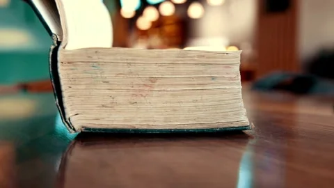 A hand turns the page of an old book Video stock 332284384