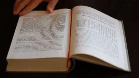 Hand turns pages of the book Stock Footage 42724974