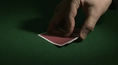 Hand turns playing cards Stock Footage 10814325