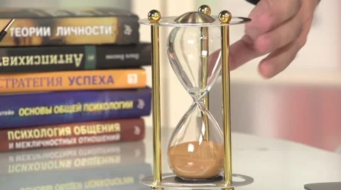 The hand turns sand clock to start. Stock Footage 60814973