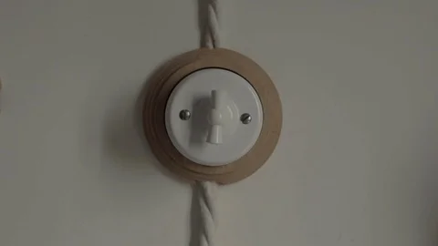 Hand turns switch on and then off in bright room Vidéo 112449353