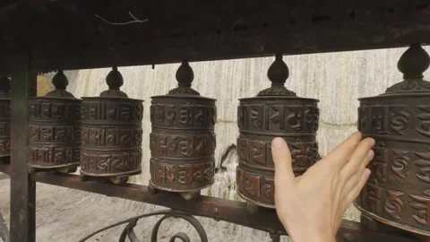 Hand turns Tibetan prayer wheels at Swayambhunath Temple, Kathmandu, Nepal Stock Footage 346710153