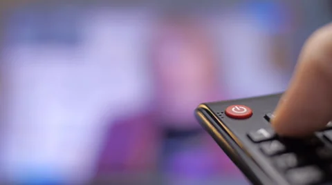 Hand turns on the TV and switch the channels by remote control Stock Footage 61056660