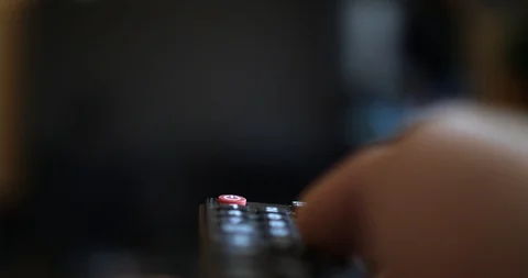 Hand turns on the TV and switch the channels by remote control er. Stock Footage 88732075