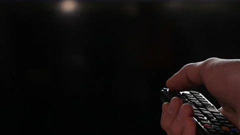 Hand turns on the TV and switch the channels by remote control. Video stock 151403311